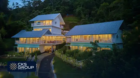 grand valley munnar hotel on hill with clouds and greenery view
